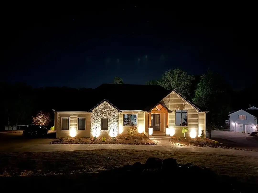 Landscape lighting illuminating a home at night